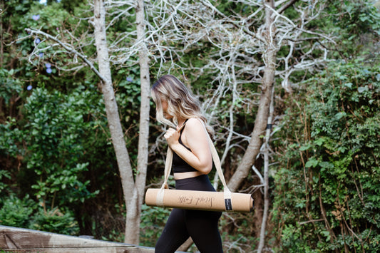 Yogi walking with Second Earth Cork Yoga Mat on her shoulder