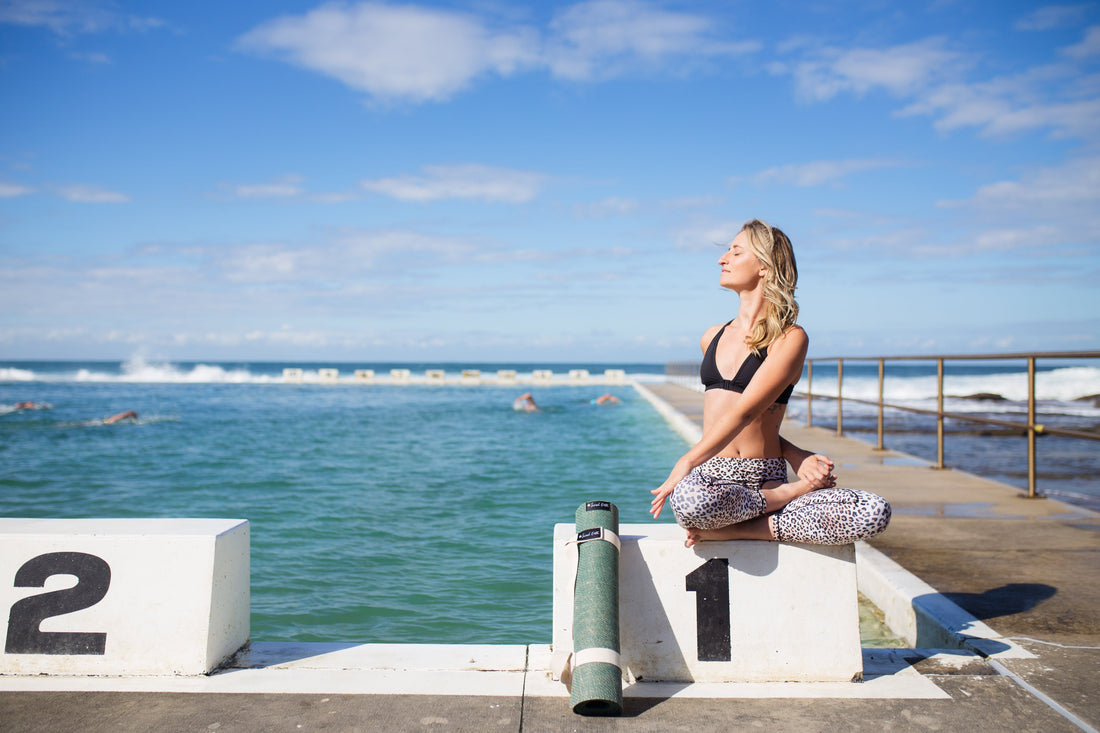 Yogi stretching at Ocean Baths in the sun