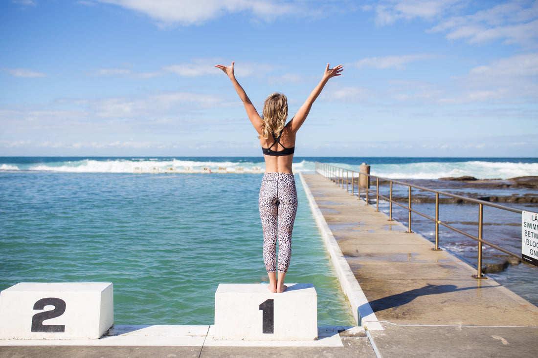 Yogi standing on block at ocean baths