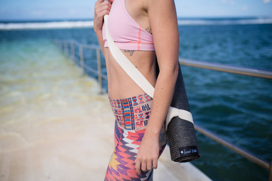 Yogi at the ocean baths with a Second Earth Yoga mat on her back